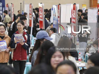 College students are choosing positions at a campus job fair in Huai'an, China, on April 27, 2024. (