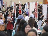 College students are choosing positions at a campus job fair in Huai'an, China, on April 27, 2024. (