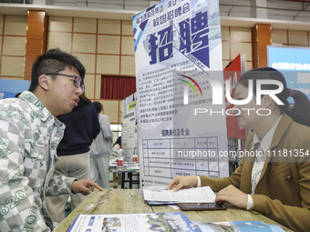 College students are choosing positions at a campus job fair in Huai'an, China, on April 27, 2024. (