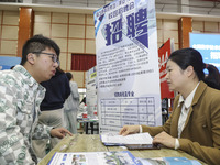 College students are choosing positions at a campus job fair in Huai'an, China, on April 27, 2024. (