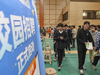 College students are choosing positions at a campus job fair in Huai'an, China, on April 27, 2024. (