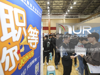 College students are choosing positions at a campus job fair in Huai'an, China, on April 27, 2024. (