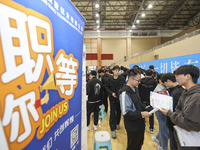 College students are choosing positions at a campus job fair in Huai'an, China, on April 27, 2024. (