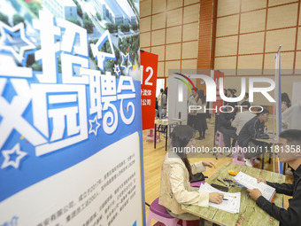 College students are choosing positions at a campus job fair in Huai'an, China, on April 27, 2024. (