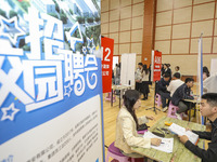 College students are choosing positions at a campus job fair in Huai'an, China, on April 27, 2024. (