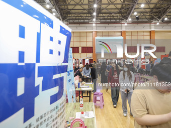 College students are choosing positions at a campus job fair in Huai'an, China, on April 27, 2024. (