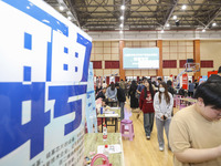 College students are choosing positions at a campus job fair in Huai'an, China, on April 27, 2024. (