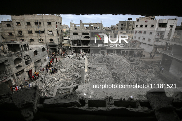 Palestinians are checking the damage in a house that was destroyed by an overnight Israeli bombardment in Nuseirat camp in the central Gaza...