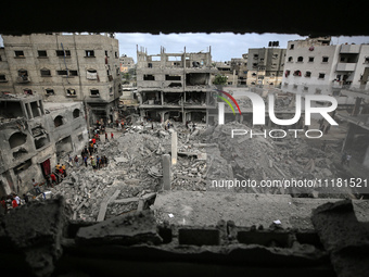 Palestinians are checking the damage in a house that was destroyed by an overnight Israeli bombardment in Nuseirat camp in the central Gaza...