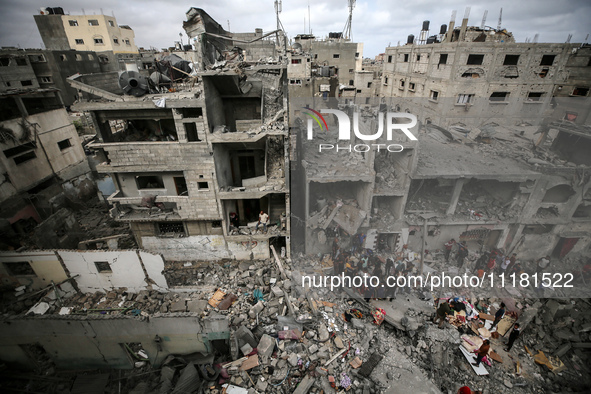 Palestinians are checking the damage in a house that was destroyed by an overnight Israeli bombardment in Nuseirat camp in the central Gaza...