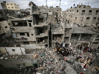 Palestinians are checking the damage in a house that was destroyed by an overnight Israeli bombardment in Nuseirat camp in the central Gaza...