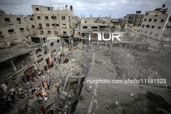 Palestinians are checking the damage in a house that was destroyed by an overnight Israeli bombardment in Nuseirat camp in the central Gaza...