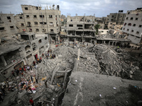 Palestinians are checking the damage in a house that was destroyed by an overnight Israeli bombardment in Nuseirat camp in the central Gaza...