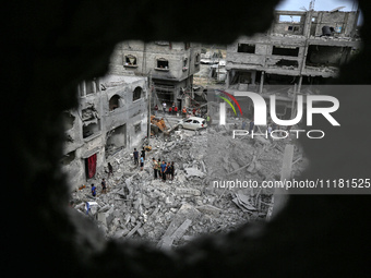 Palestinians are checking the damage in a house that was destroyed by an overnight Israeli bombardment in Nuseirat camp in the central Gaza...