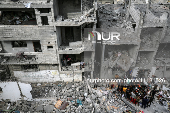 Palestinians are checking the damage in a house that was destroyed by an overnight Israeli bombardment in Nuseirat camp in the central Gaza...