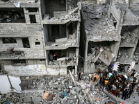 Palestinians are checking the damage in a house that was destroyed by an overnight Israeli bombardment in Nuseirat camp in the central Gaza...