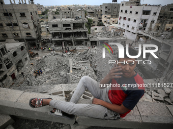 Palestinians are checking the damage in a house that was destroyed by an overnight Israeli bombardment in Nuseirat camp in the central Gaza...