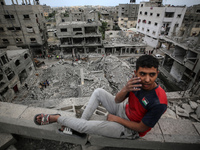 Palestinians are checking the damage in a house that was destroyed by an overnight Israeli bombardment in Nuseirat camp in the central Gaza...