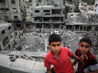 Palestinians are checking the damage in a house that was destroyed by an overnight Israeli bombardment in Nuseirat camp in the central Gaza...