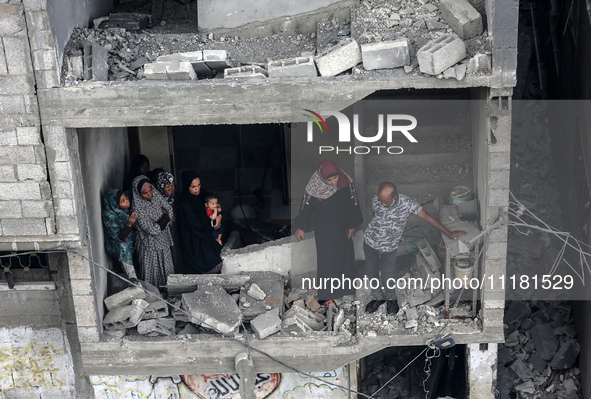 Palestinians are checking the damage in a house that was destroyed by an overnight Israeli bombardment in Nuseirat camp in the central Gaza...