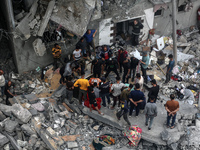 Palestinians are checking the damage in a house that was destroyed by an overnight Israeli bombardment in Nuseirat camp in the central Gaza...