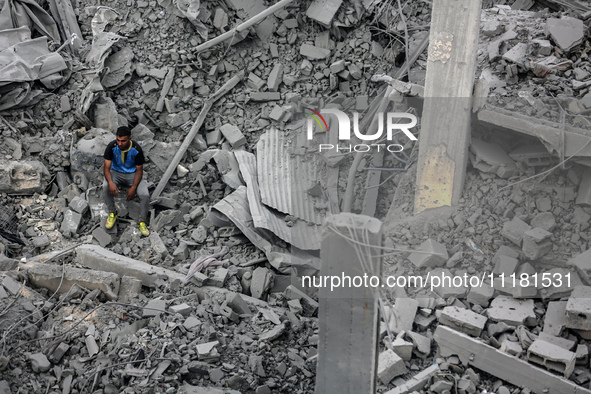 A Palestinian is inspecting the damage in a house that was destroyed by an overnight Israeli bombardment in Nuseirat camp in the central Gaz...