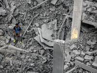 A Palestinian is inspecting the damage in a house that was destroyed by an overnight Israeli bombardment in Nuseirat camp in the central Gaz...