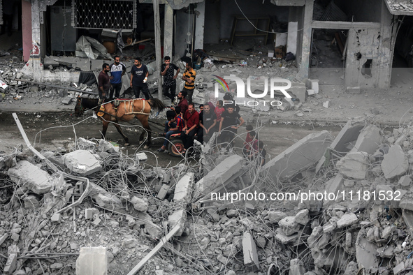 Palestinians are checking the damage in a house that was destroyed by an overnight Israeli bombardment in Nuseirat camp in the central Gaza...