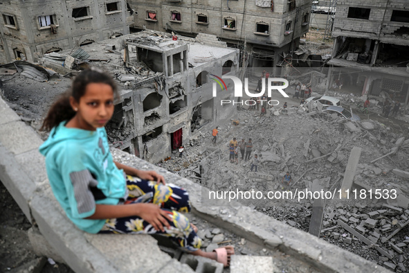 Palestinians are checking the damage in a house that was destroyed by an overnight Israeli bombardment in Nuseirat camp in the central Gaza...