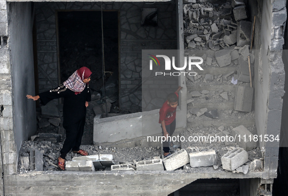 Palestinians are checking the damage in a house that was destroyed by an overnight Israeli bombardment in Nuseirat camp in the central Gaza...