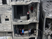 Palestinians are checking the damage in a house that was destroyed by an overnight Israeli bombardment in Nuseirat camp in the central Gaza...