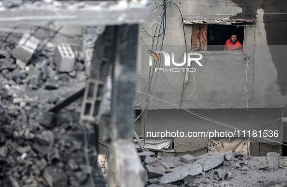 A Palestinian is inspecting the damage in a house that was destroyed by an overnight Israeli bombardment in Nuseirat camp in the central Gaz...