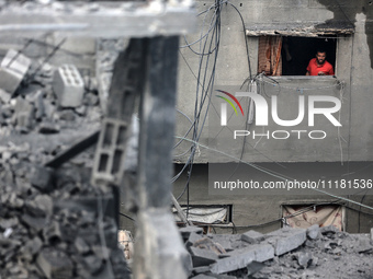 A Palestinian is inspecting the damage in a house that was destroyed by an overnight Israeli bombardment in Nuseirat camp in the central Gaz...