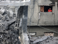 A Palestinian is inspecting the damage in a house that was destroyed by an overnight Israeli bombardment in Nuseirat camp in the central Gaz...