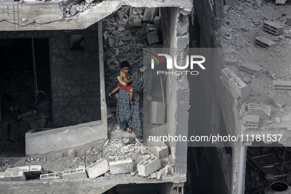 A Palestinian is inspecting the damage in a house that was destroyed by an overnight Israeli bombardment in Nuseirat camp in the central Gaz...