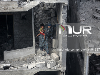 A Palestinian is inspecting the damage in a house that was destroyed by an overnight Israeli bombardment in Nuseirat camp in the central Gaz...