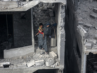 A Palestinian is inspecting the damage in a house that was destroyed by an overnight Israeli bombardment in Nuseirat camp in the central Gaz...