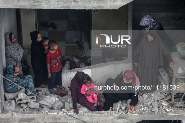 Palestinians are checking the damage in a house that was destroyed by an overnight Israeli bombardment in Nuseirat camp in the central Gaza...