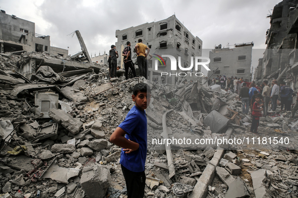 Palestinians are checking the damage in a house that was destroyed by an overnight Israeli bombardment in Nuseirat camp in the central Gaza...