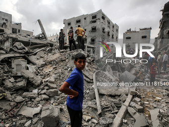 Palestinians are checking the damage in a house that was destroyed by an overnight Israeli bombardment in Nuseirat camp in the central Gaza...