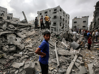 Palestinians are checking the damage in a house that was destroyed by an overnight Israeli bombardment in Nuseirat camp in the central Gaza...