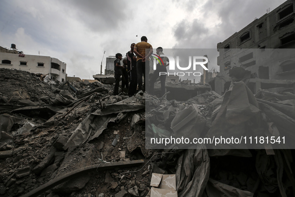 Palestinians are checking the damage in a house that was destroyed by an overnight Israeli bombardment in Nuseirat camp in the central Gaza...