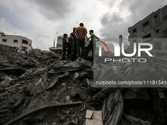 Palestinians are checking the damage in a house that was destroyed by an overnight Israeli bombardment in Nuseirat camp in the central Gaza...