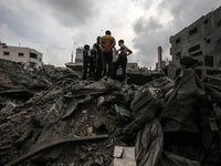 Palestinians are checking the damage in a house that was destroyed by an overnight Israeli bombardment in Nuseirat camp in the central Gaza...