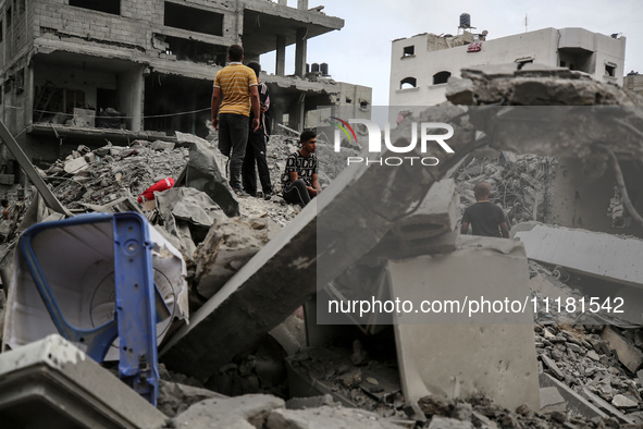 Palestinians are checking the damage in a house that was destroyed by an overnight Israeli bombardment in Nuseirat camp in the central Gaza...