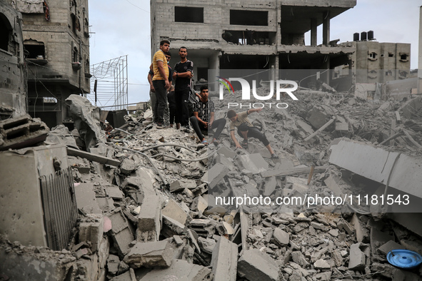 Palestinians are checking the damage in a house that was destroyed by an overnight Israeli bombardment in Nuseirat camp in the central Gaza...