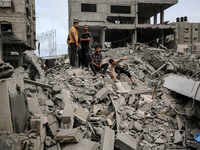 Palestinians are checking the damage in a house that was destroyed by an overnight Israeli bombardment in Nuseirat camp in the central Gaza...