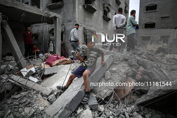 Palestinians are checking the damage in a house that was destroyed by an overnight Israeli bombardment in Nuseirat camp in the central Gaza...