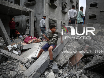 Palestinians are checking the damage in a house that was destroyed by an overnight Israeli bombardment in Nuseirat camp in the central Gaza...