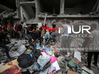 Palestinians are checking the damage in a house that was destroyed by an overnight Israeli bombardment in Nuseirat camp in the central Gaza...